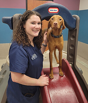 Erin Taylor, Pet Resort Manager, with a dog at Blue Springs Pet Resort